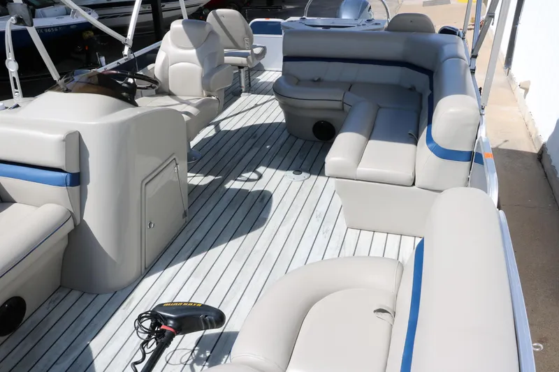 Slide: The Image of 2017 Berkshire 211RFC CTS pontoon boat interior with beige seating and steering console. - 14