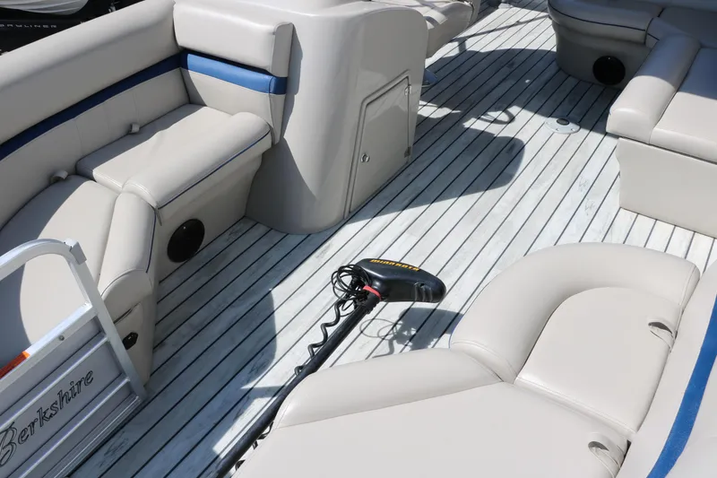 Slide: The Image of 2017 Berkshire 211RFC CTS boat interior with beige seating and striped flooring. - 15