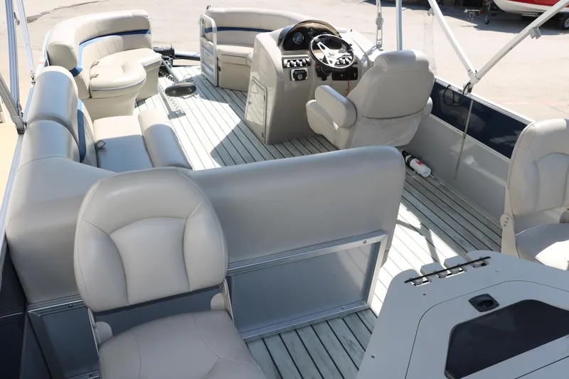 Slide: The Image of 2017 Berkshire 211RFC CTS pontoon boat interior with plush seating and modern helm. - 17