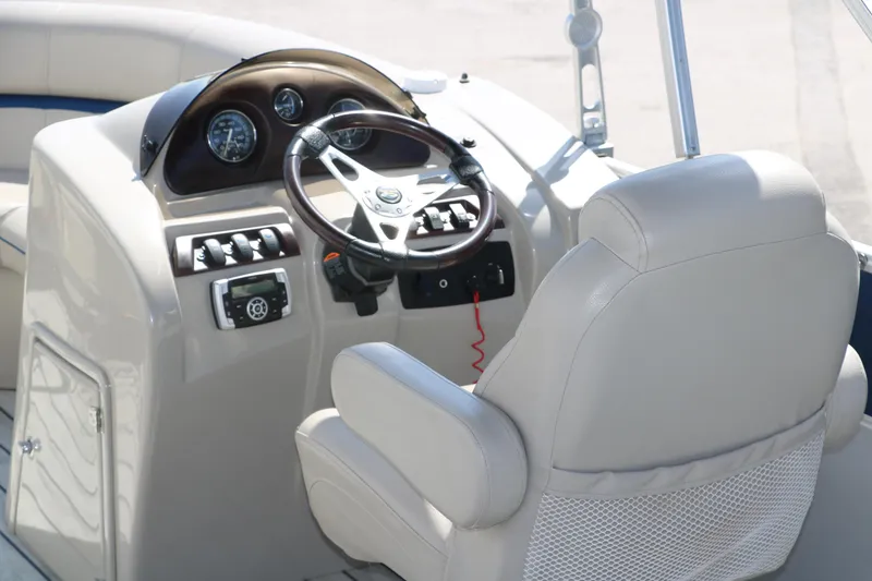 Slide: The Image of 2017 Berkshire 211RFC CTS boat helm with steering wheel and control panel. - 19