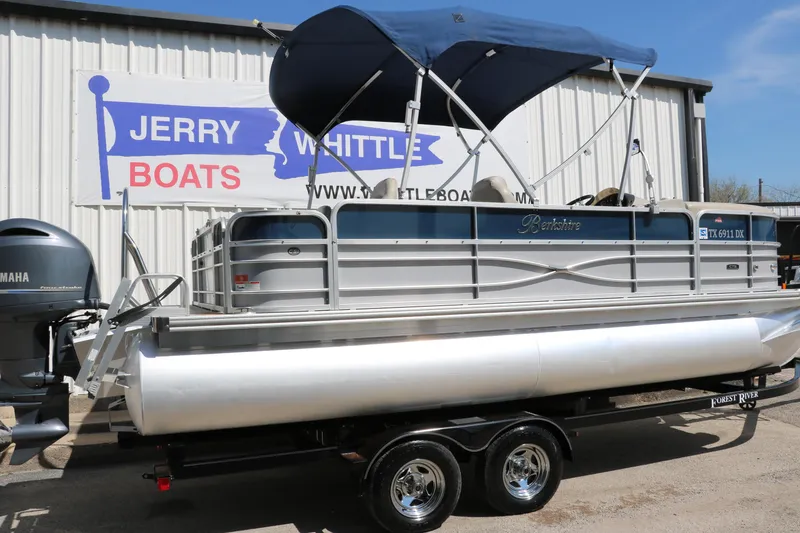 Slide: The Image of 2017 Berkshire 211RFC CTS pontoon boat with blue canopy on trailer at dealership. - 2