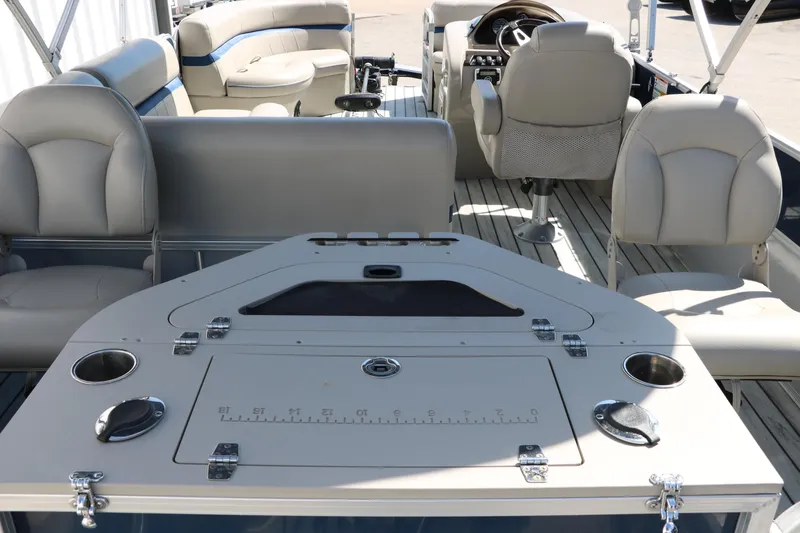 Slide: The Image of 2017 Berkshire 211RFC CTS pontoon boat interior with seating and control panel. - 21