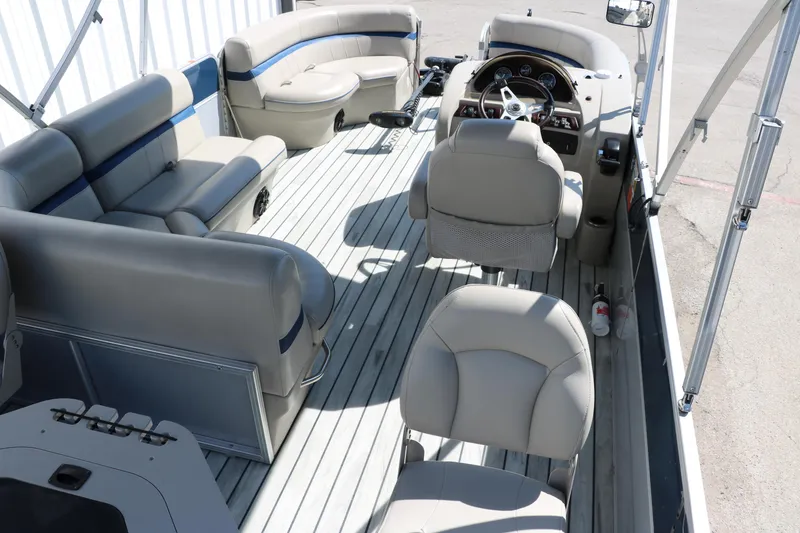 Slide: The Image of 2017 Berkshire 211RFC CTS pontoon boat interior with beige seating and steering console. - 22