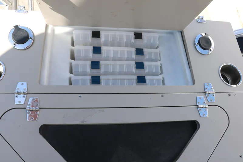Slide: The Image of 2017 Berkshire 211RFC CTS storage compartment with organized tackle boxes and secure latches. - 25