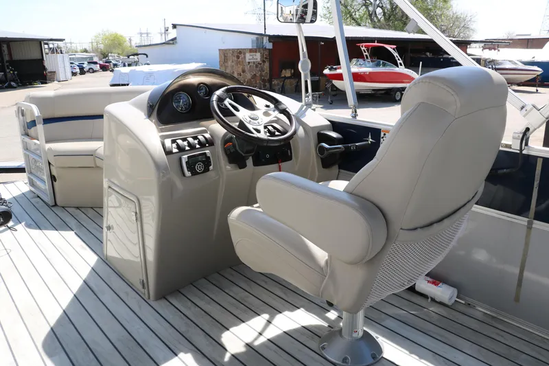 Slide: The Image of 2017 Berkshire 211RFC CTS boat interior with steering console and captain's chair. - 26