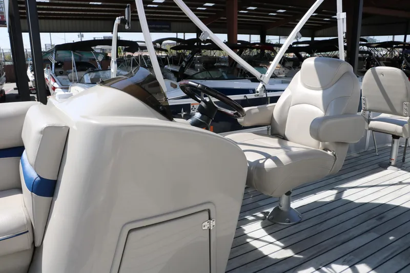 Slide: The Image of 2017 Berkshire 211RFC CTS boat interior with captain's chair and steering wheel. - 31