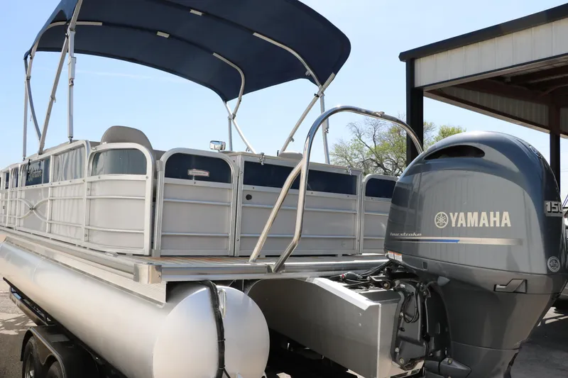 Slide: The Image of 2017 Berkshire 211RFC CTS pontoon boat with Yamaha outboard motor, docked under a canopy. - 6