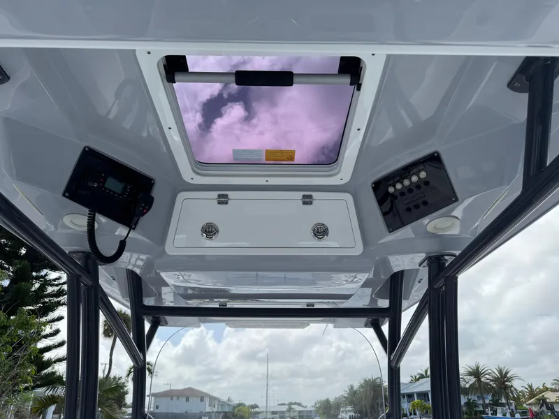 Slide: The Image of 2023 Sea Fox 328 Commander boat interior with control panels and skylight. - 16