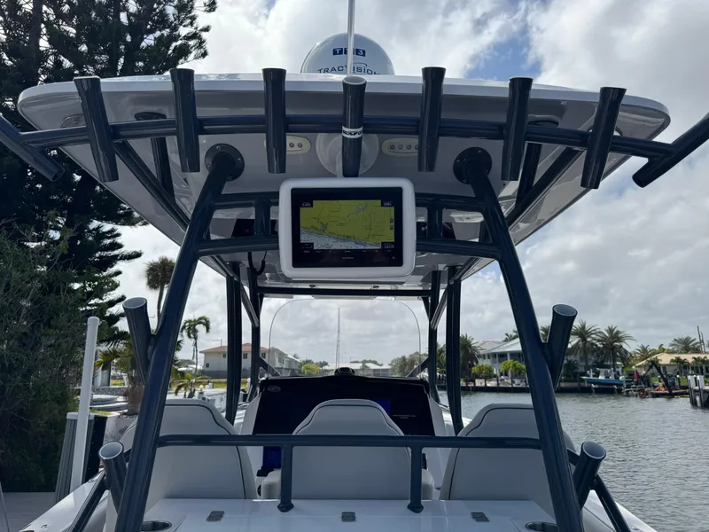 Slide: The Image of 2023 Sea Fox 328 Commander boat with advanced navigation system, docked by a scenic canal. - 19