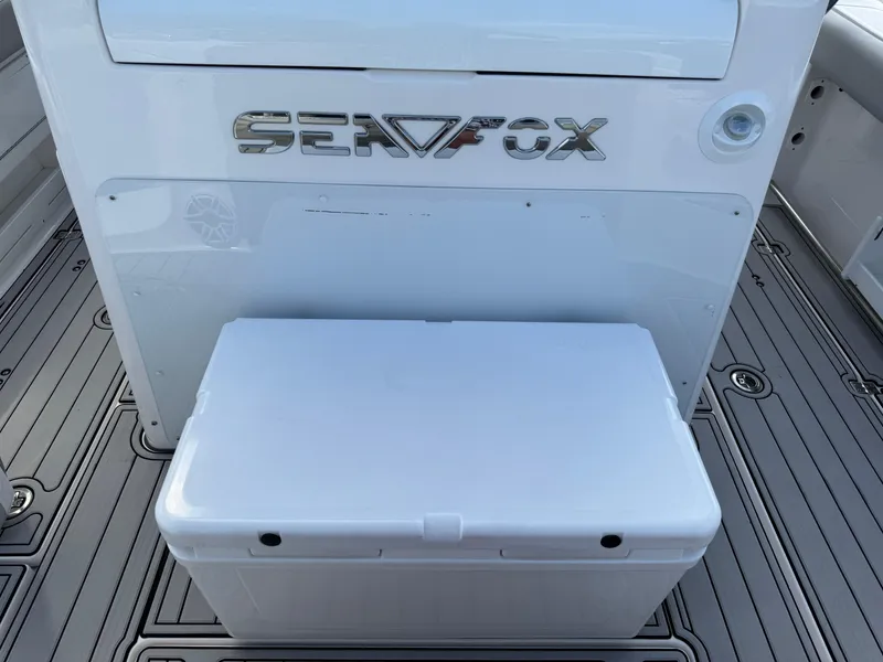 Slide: The Image of 2023 Sea Fox 328 Commander boat interior with cooler and logo. - 23