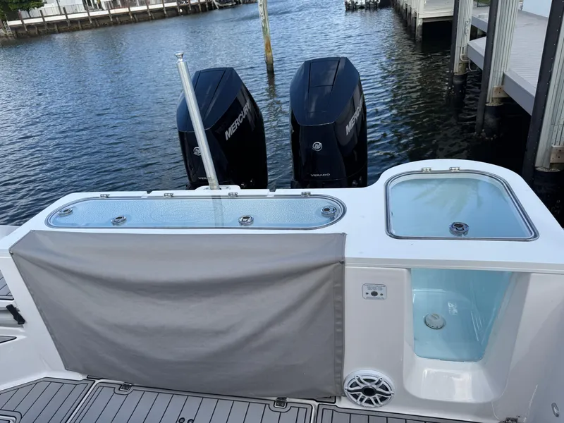 Slide: The Image of 2023 Sea Fox 328 Commander boat with dual Mercury engines docked by the water. - 27