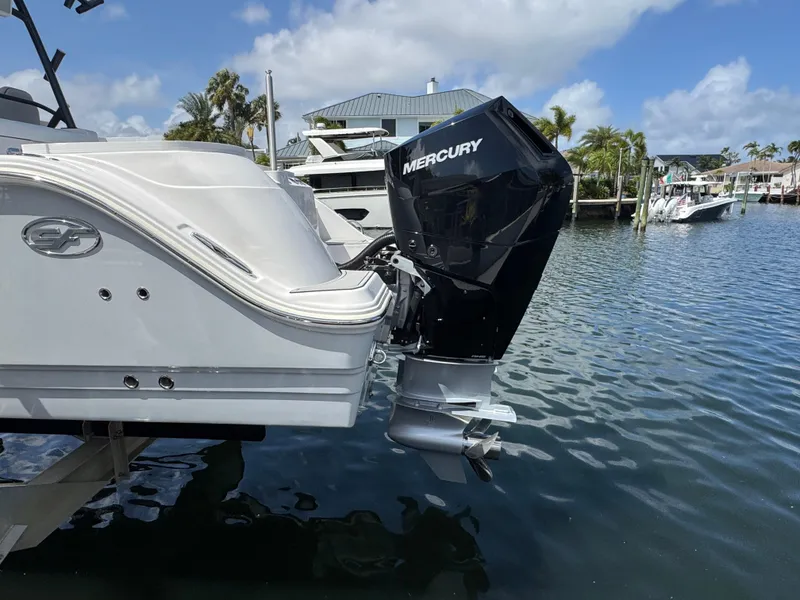Slide: The Image of 2023 Sea Fox 328 Commander with Mercury outboard motor docked by waterfront homes. - 3