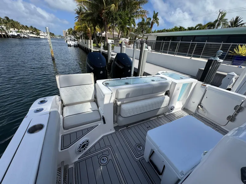 Slide: The Image of 2023 Sea Fox 328 Commander boat docked, featuring spacious seating and dual engines. - 31