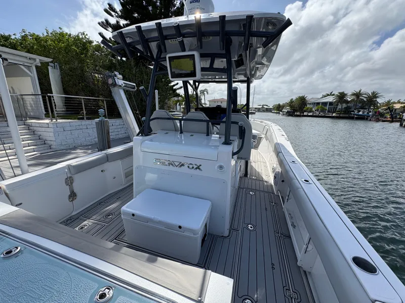Slide: The Image of 2023 Sea Fox 328 Commander boat docked by a scenic waterfront. - 35