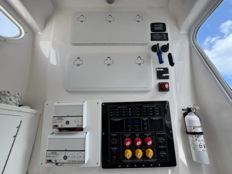 Slide: The Image of 2023 Sea Fox 328 Commander control panel with switches, gauges, and fire extinguisher. - 37