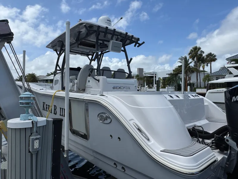 Slide: The Image of 2023 Sea Fox 328 Commander boat docked under a partly cloudy sky. - 4