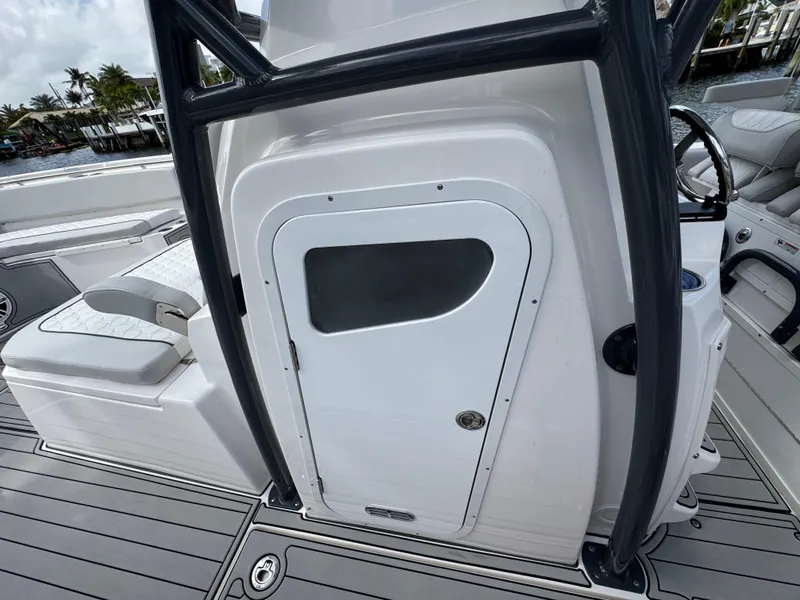 Slide: The Image of 2023 Sea Fox 328 Commander boat interior with sleek white cabin door and seating. - 46