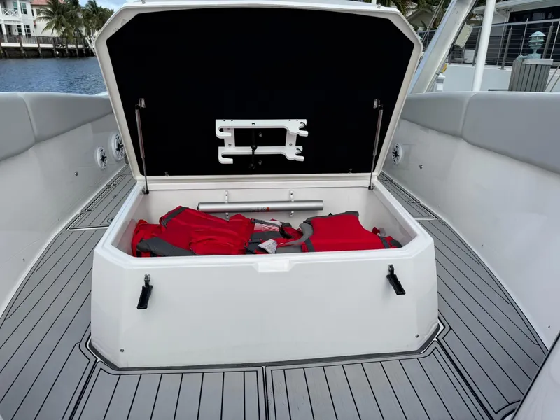 Slide: The Image of 2023 Sea Fox 328 Commander storage compartment with red life jackets on deck. - 48