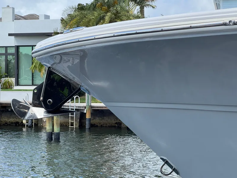Slide: The Image of 2023 Sea Fox 328 Commander boat bow with anchor, docked near waterfront home. - 7