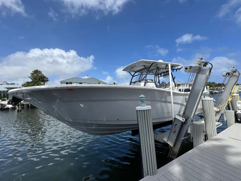 Slide: The Image of 2023 Sea Fox 328 Commander boat docked, showcasing sleek design and modern features. - 8