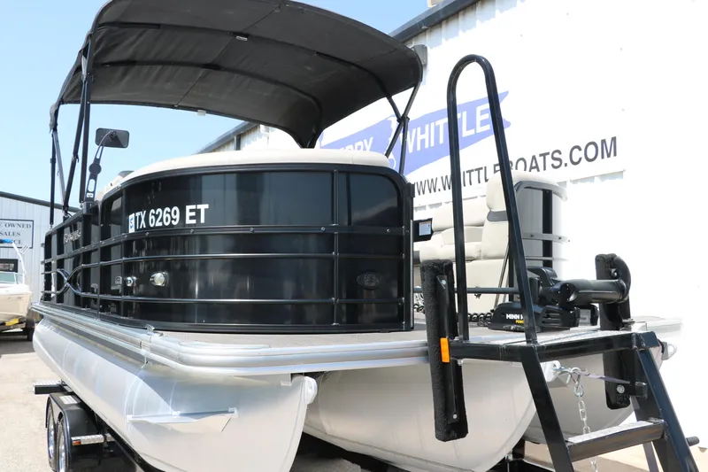 Slide: The Image of 2019 Berkshire 211RFC CTS pontoon boat with black canopy and trailer. - 10