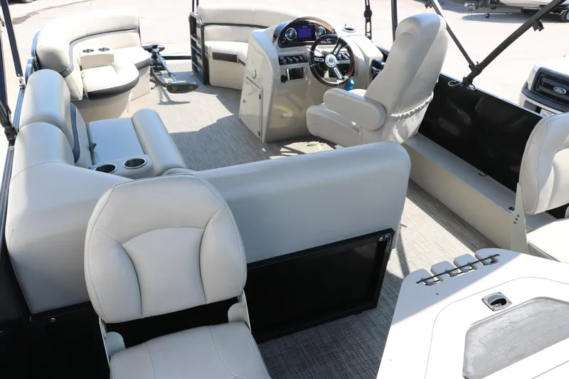 Slide: The Image of 2019 Berkshire 211RFC CTS pontoon boat interior with plush seating and modern dashboard. - 20