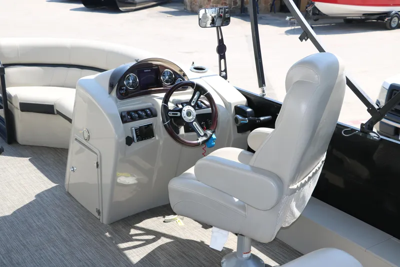 Slide: The Image of 2019 Berkshire 211RFC CTS boat interior with steering wheel and seating. - 27