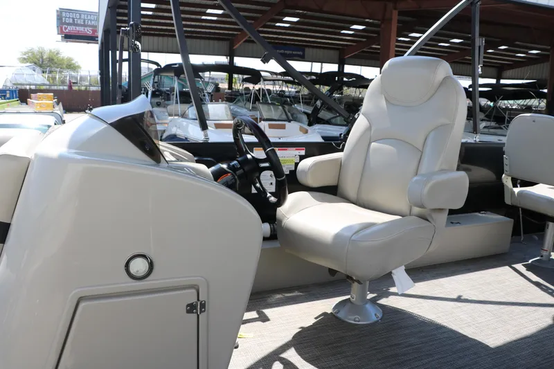 Slide: The Image of 2019 Berkshire 211RFC CTS boat interior with captain's chair and steering console. - 31