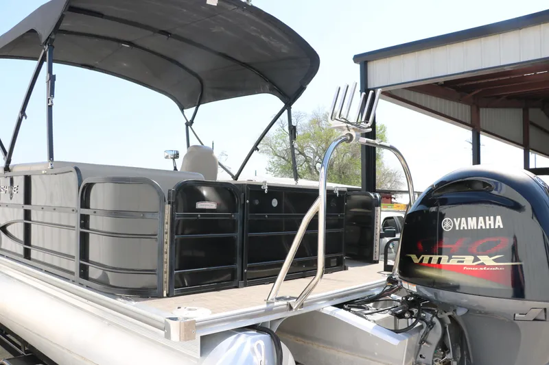 Slide: The Image of 2019 Berkshire 211RFC CTS pontoon boat with Yamaha VMAX engine, docked under a canopy. - 6