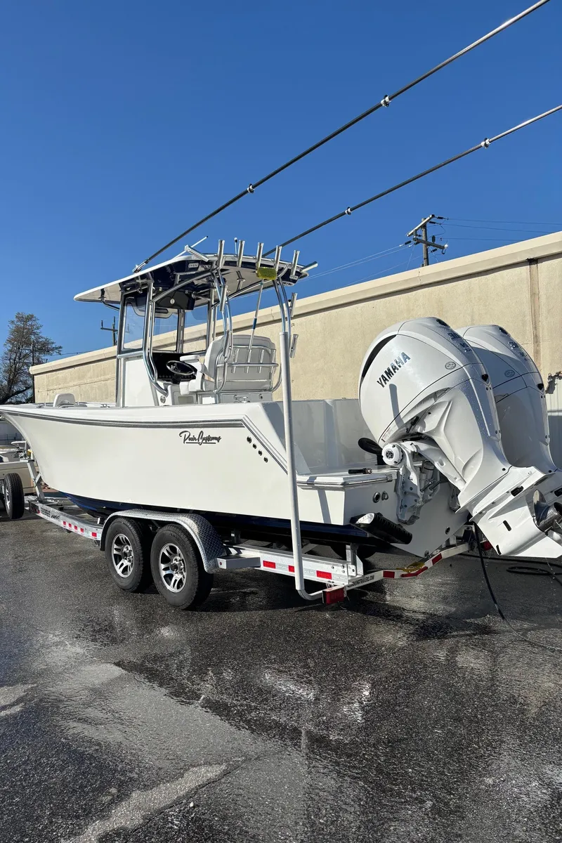 Slide: The Image of 2025 Pair Customs 28 Center Console boat on trailer with Yamaha outboard engines. - 12