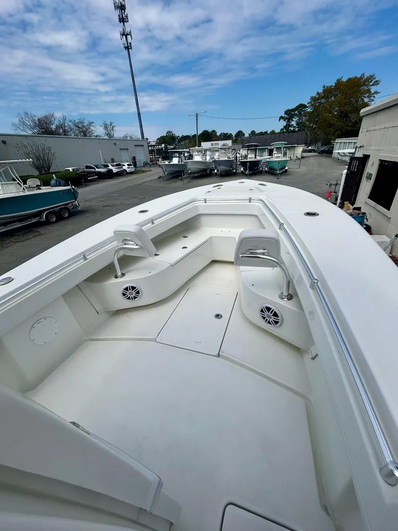 Slide: The Image of 2025 Pair Customs 28 Center Console boat with spacious deck and seating, docked outdoors. - 3