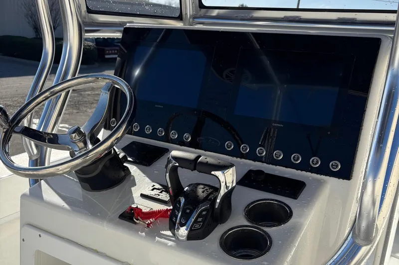 Slide: The Image of 2025 Pair Customs 28 Center Console boat dashboard with steering wheel and controls. - 9