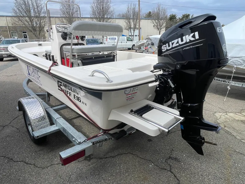 Slide: The Image of 2025 Carolina Skiff E16 JVX CC boat on trailer with Suzuki outboard motor. - 3