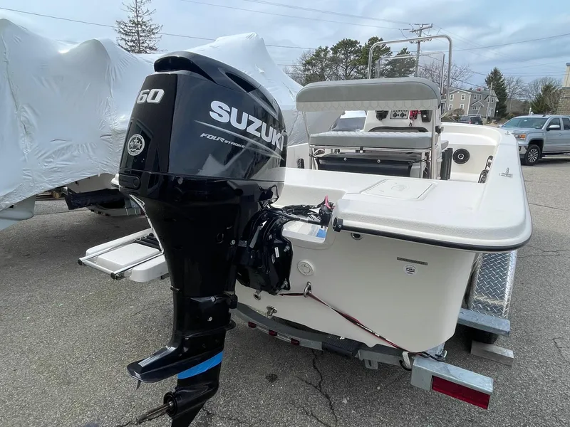 Slide: The Image of 2025 Carolina Skiff E16 JVX CC boat with Suzuki outboard motor on trailer. - 4
