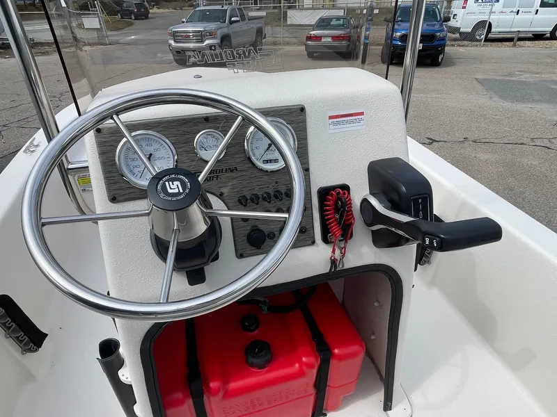 Slide: The Image of 2025 Carolina Skiff E16 JVX CC boat console with steering wheel and gauges. - 5