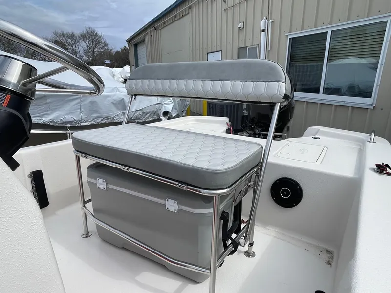 Slide: The Image of 2025 Carolina Skiff E16 JVX CC boat interior with cushioned seating and steering wheel. - 9