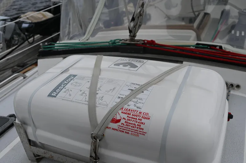 Slide: The Image of Life raft on 1984 Southern Cross 39 sailboat deck, secured with straps. - 22