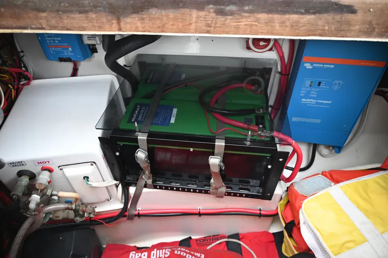 Slide: The Image of Electrical system setup in a 1984 Southern Cross 39 sailboat, featuring battery and wiring. - 30