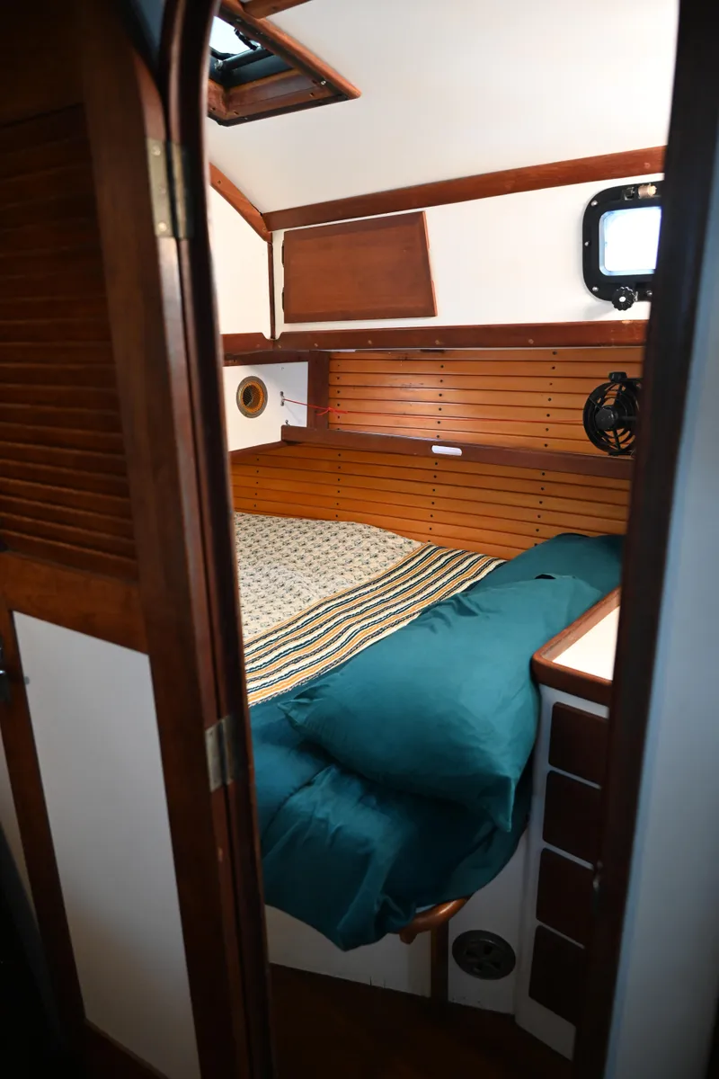 Slide: The Image of Cozy cabin interior of 1984 Southern Cross 39 sailboat with wooden accents and bedding. - 31