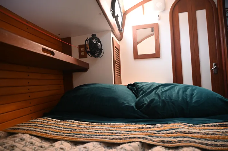 Slide: The Image of Cozy cabin interior of 1984 Southern Cross 39 sailboat with bed and wooden accents. - 32