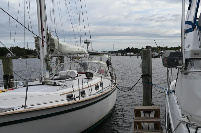 Slide: The Image of 1984 Southern Cross 39 sailboat docked at a marina under cloudy skies. - 5