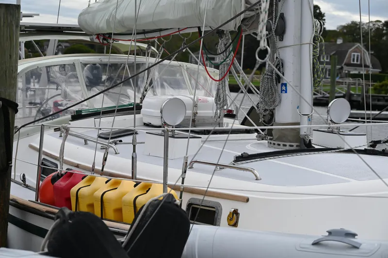 Slide: The Image of 1984 Southern Cross 39 sailboat docked, featuring deck details and fuel containers. - 9
