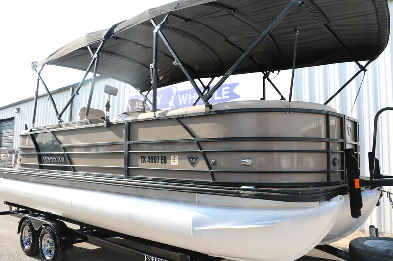 Slide: The Image of 2018 Trifecta 23 RFE pontoon boat with canopy on trailer, side view. - 11