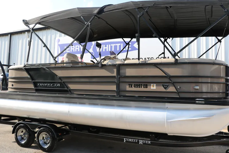 Slide: The Image of 2018 Trifecta 23 RFE pontoon boat with canopy on trailer, side view. - 12