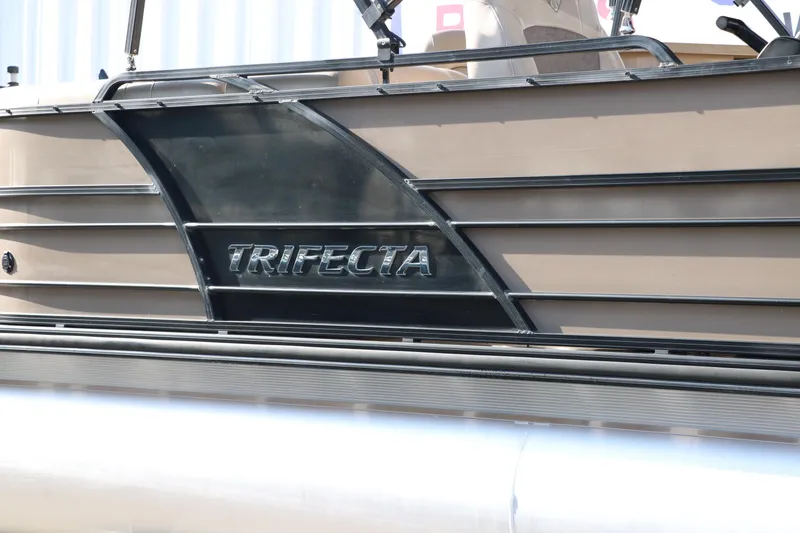 Slide: The Image of 2018 Trifecta 23 RFE pontoon boat side view with logo detail. - 13