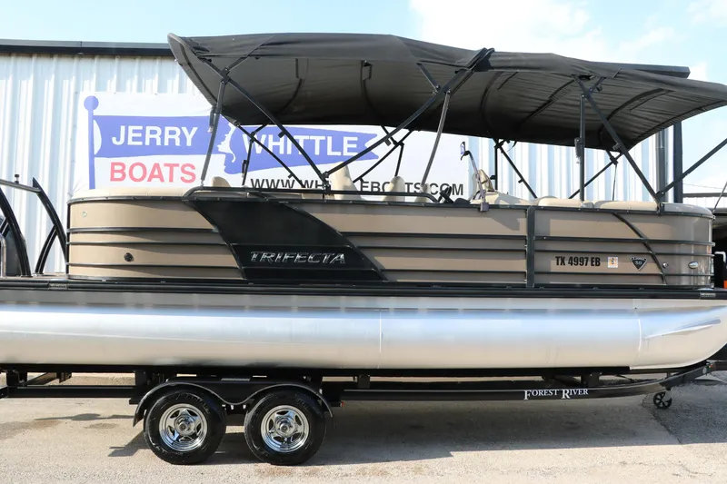 Slide: The Image of 2018 Trifecta 23 RFE pontoon boat with canopy on trailer at dealership. - 14