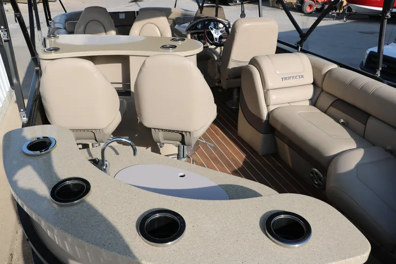 Slide: The Image of Luxurious 2018 Trifecta 23 RFE pontoon boat interior with plush seating and cup holders. - 22