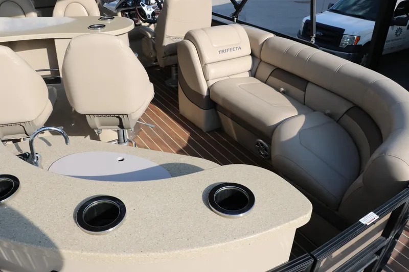 Slide: The Image of Luxurious 2018 Trifecta 23 RFE pontoon boat interior with plush seating and cup holders. - 23