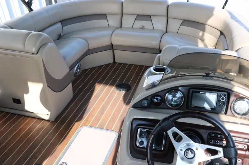 Slide: The Image of Luxurious 2018 Trifecta 23 RFE pontoon boat interior with plush seating and modern dashboard. - 26