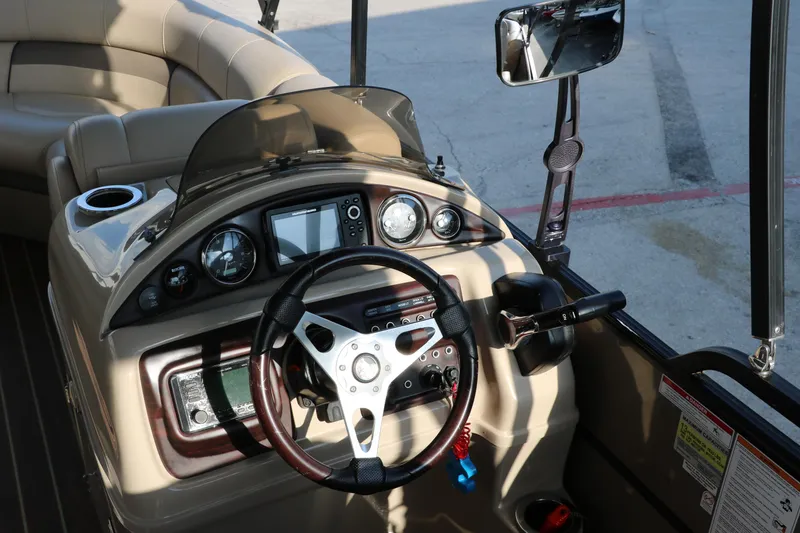 Slide: The Image of 2018 Trifecta 23 RFE boat dashboard with steering wheel and control panel. - 27